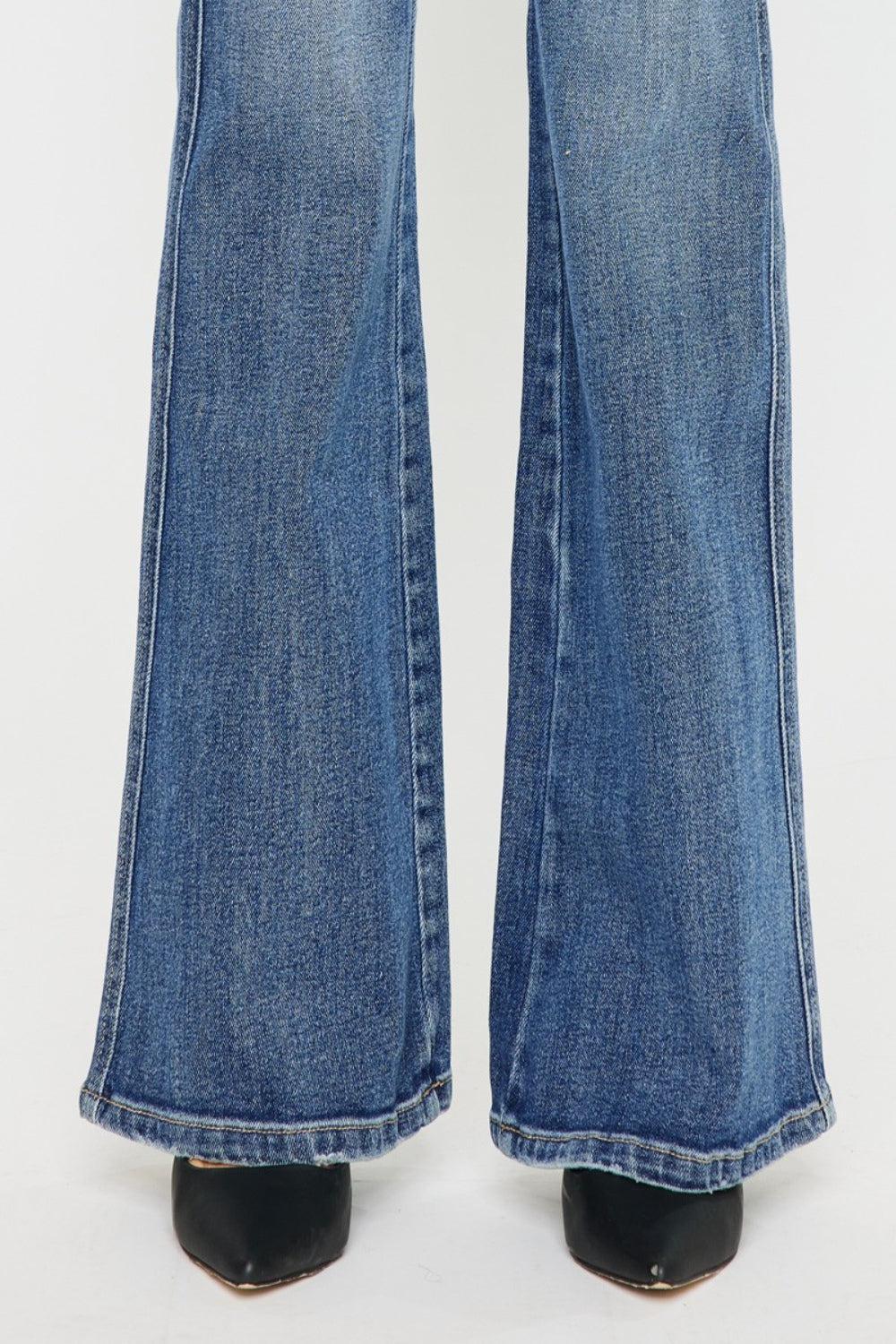 a pair of blue jeans with black heels