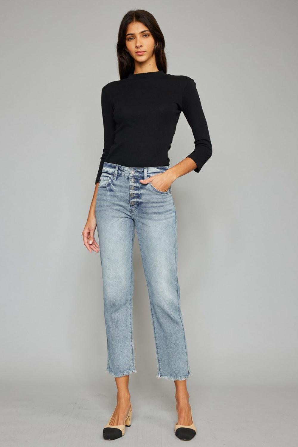 a woman wearing a black top and jeans