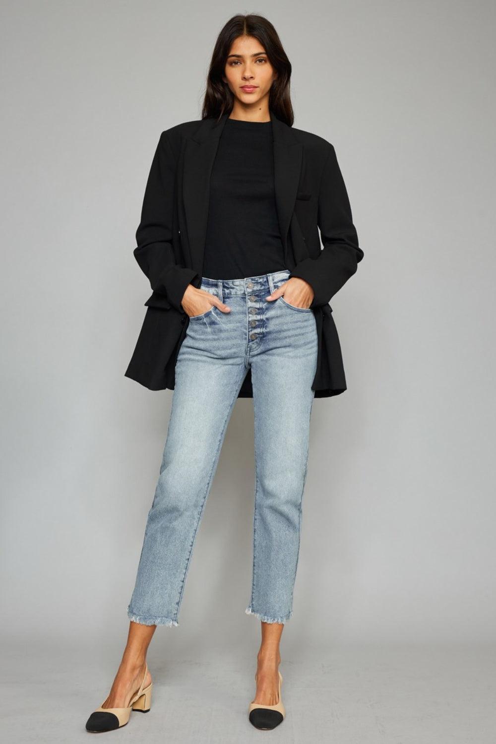 a woman wearing a black jacket and jeans
