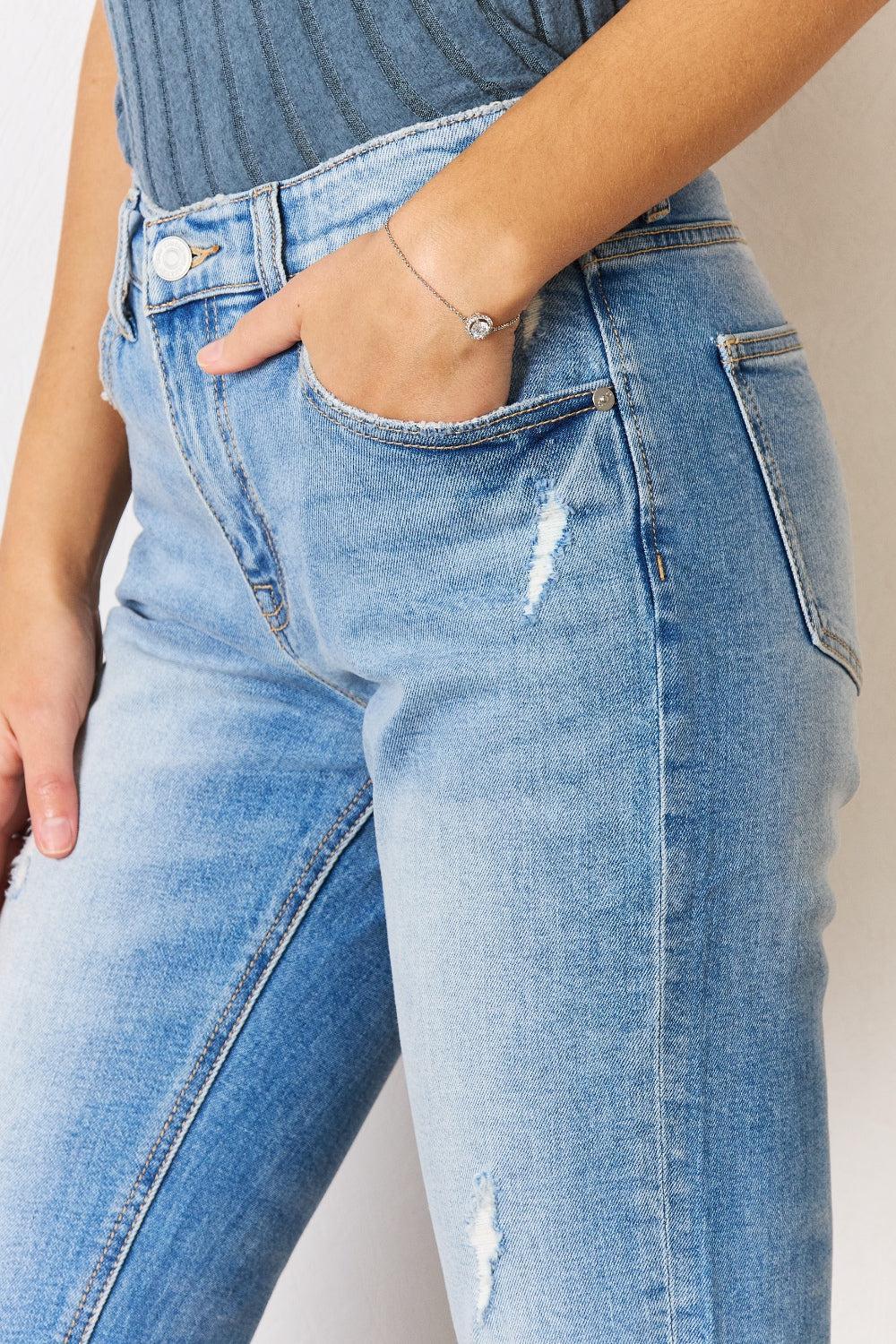 a woman wearing a pair of jeans and a ring