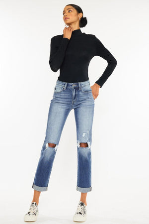 a woman in black shirt and jeans posing for a picture