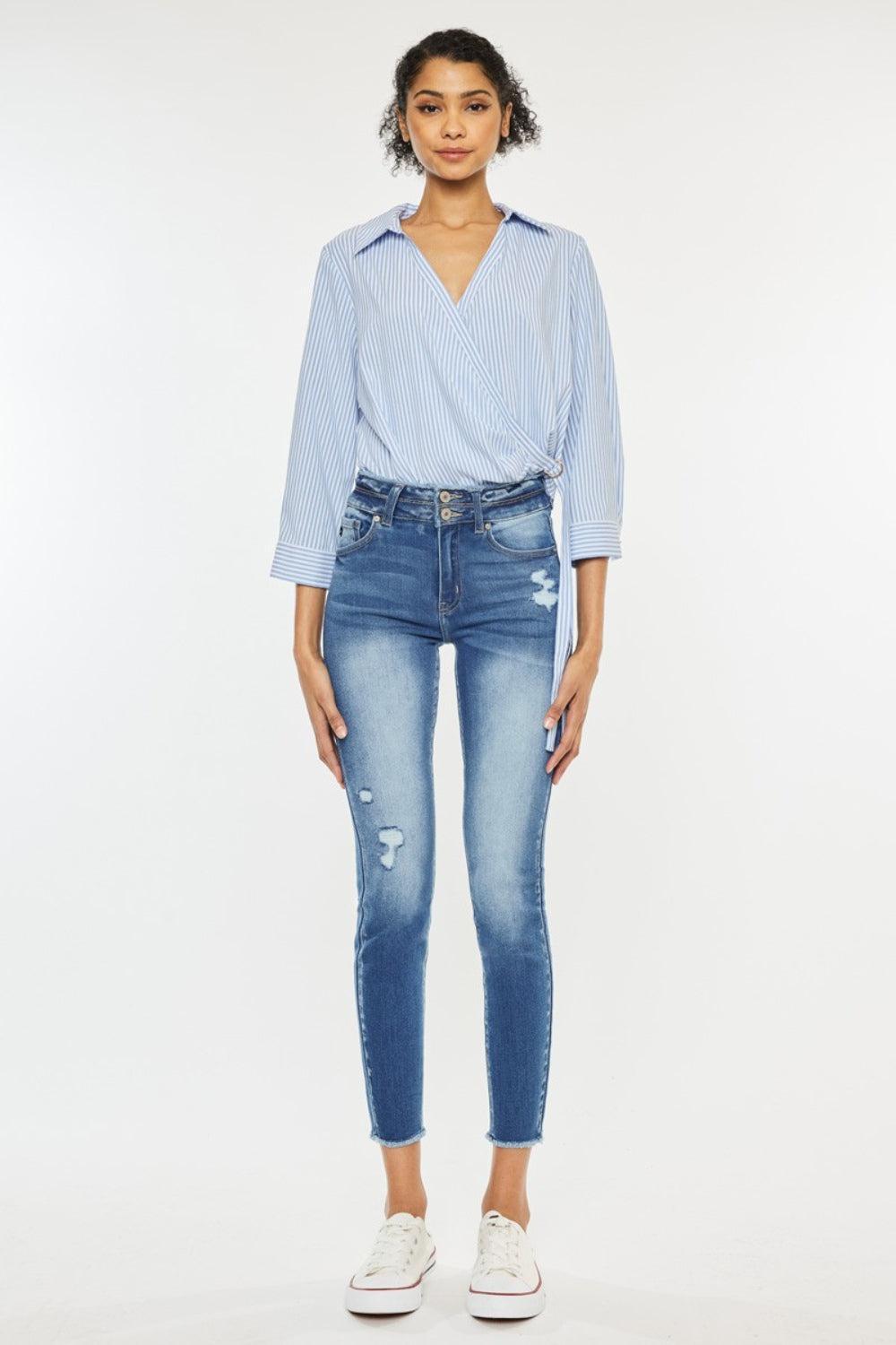 a woman in a blue shirt and jeans
