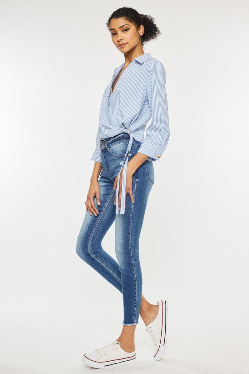 a woman in a blue shirt and jeans