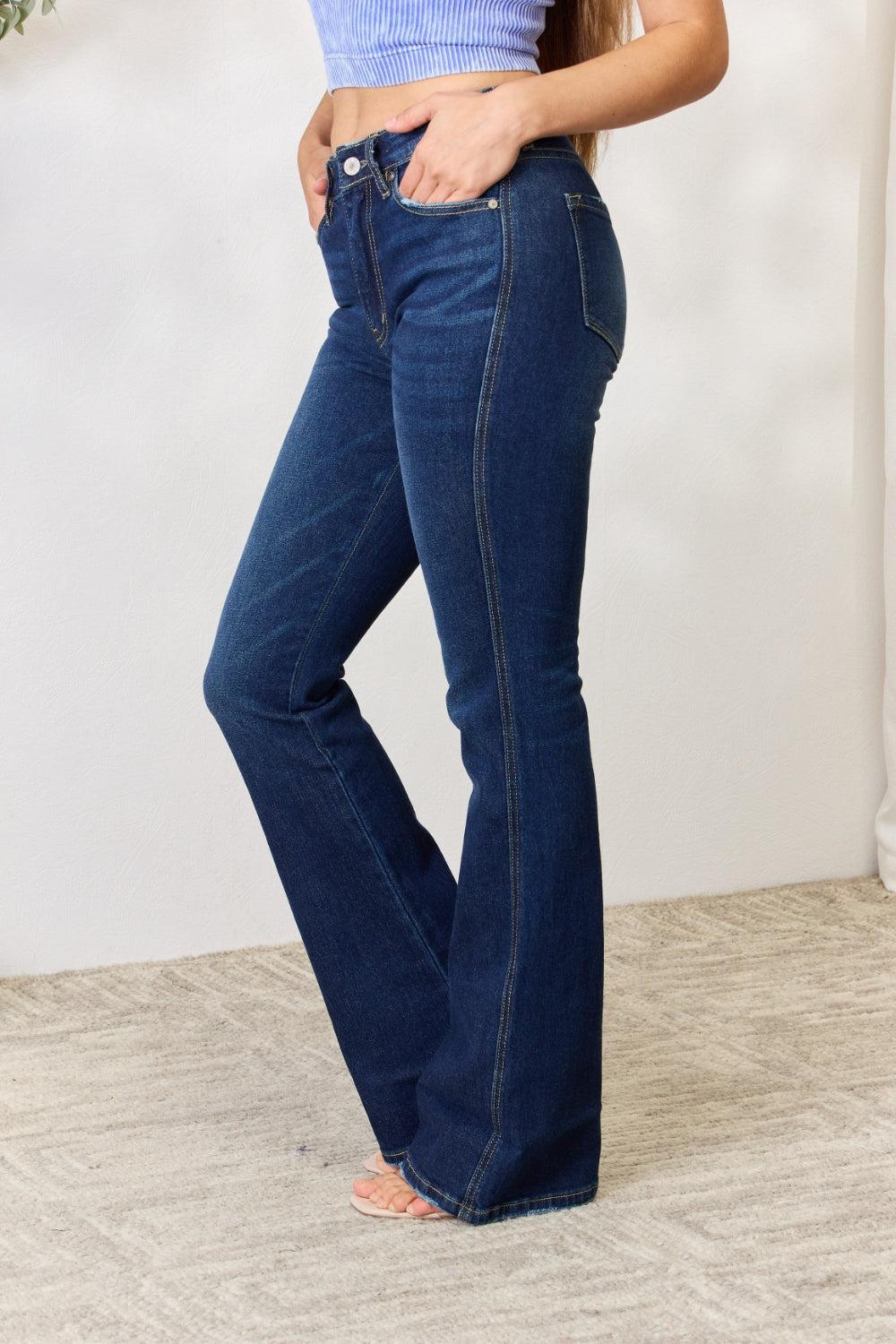 a woman wearing a blue top and jeans