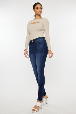 a woman in a beige top and jeans