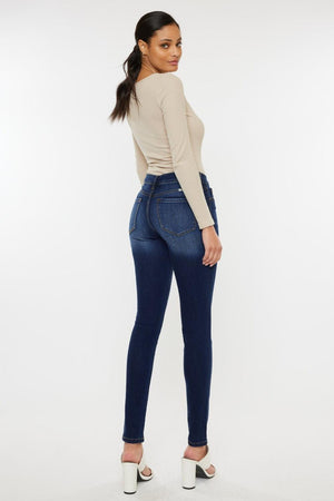 a woman in high rise jeans and heels
