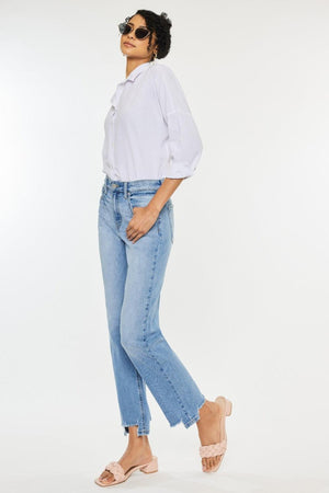 a woman wearing a white shirt and jeans