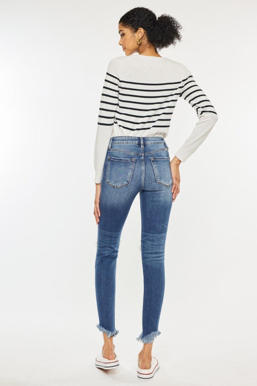 a woman wearing a striped sweater and jeans