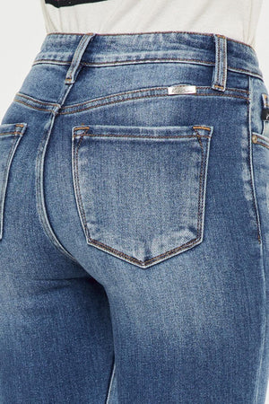 the back of a woman's jeans showing her butt