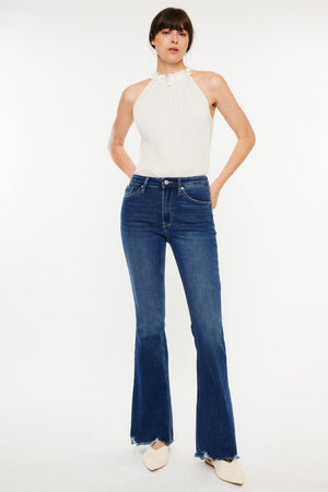 a woman in a white top and jeans