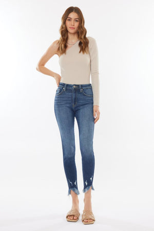 a woman in a white top and blue jeans