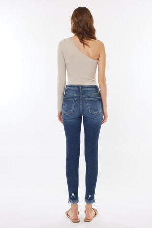 the back of a woman's jeans with a one shoulder top