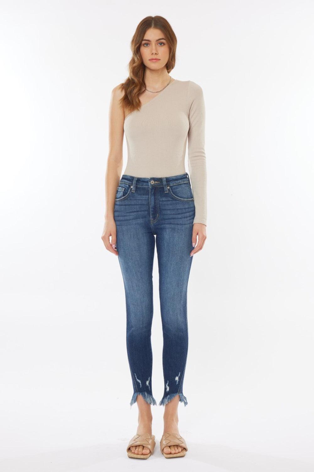 a woman in a beige top and jeans