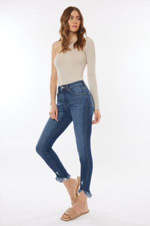 a woman in a white top and blue jeans