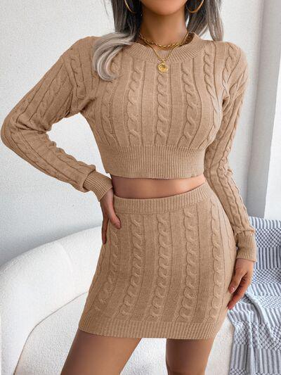 a woman wearing a tan sweater and skirt