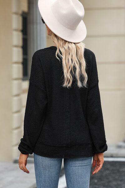 a woman wearing a white hat and black sweater
