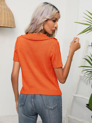 a woman in an orange shirt is brushing her hair