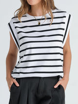 a woman wearing a black and white striped top