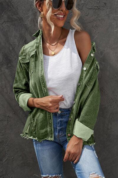 a woman wearing ripped jeans and a green jacket