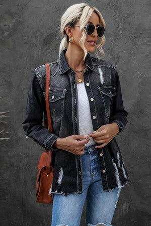 a woman wearing a denim jacket and ripped jeans
