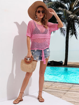 a woman in a pink shirt and hat standing next to a pool