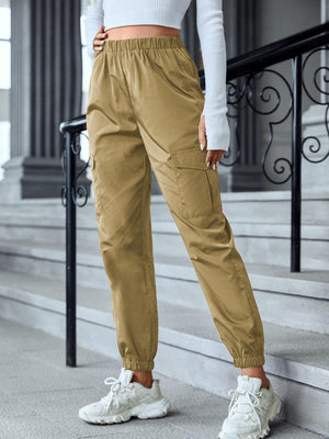 a woman in a white top and khaki pants