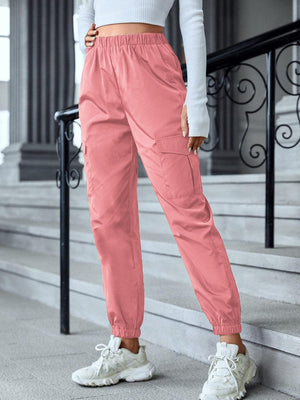 a woman in a white top and pink pants