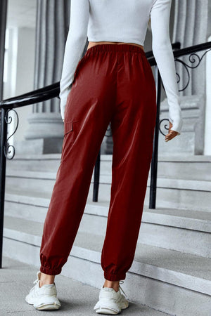 a woman in a white top and red pants