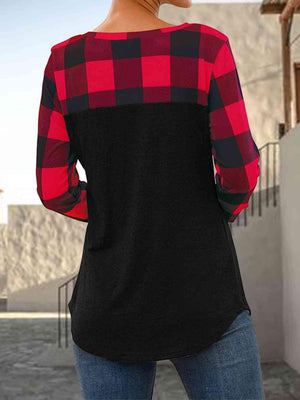 a woman wearing a red and black plaid shirt