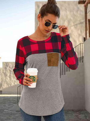 a woman holding a cup of coffee and wearing a plaid shirt