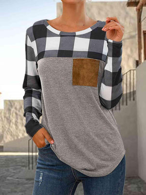 a woman wearing a gray and black checkered shirt