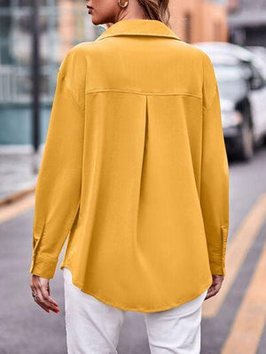 a woman walking down a street wearing a yellow shirt