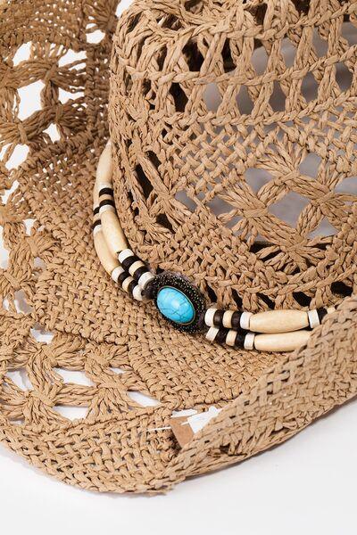 a straw hat with a turquoise beaded necklace