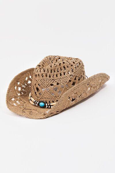 a straw cowboy hat with a turquoise bead on the brim