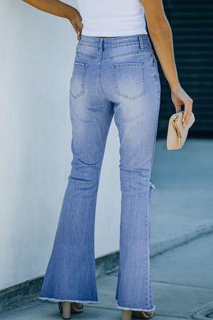 a woman in a white top and blue jeans