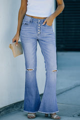 a woman in a white tank top and blue jeans