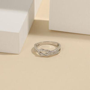 a white gold ring with a diamond set in the middle