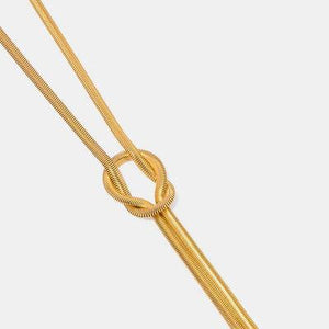 a gold necklace on a white background