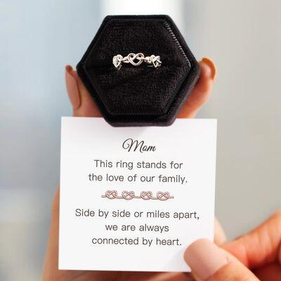 a person holding a card with a ring on it