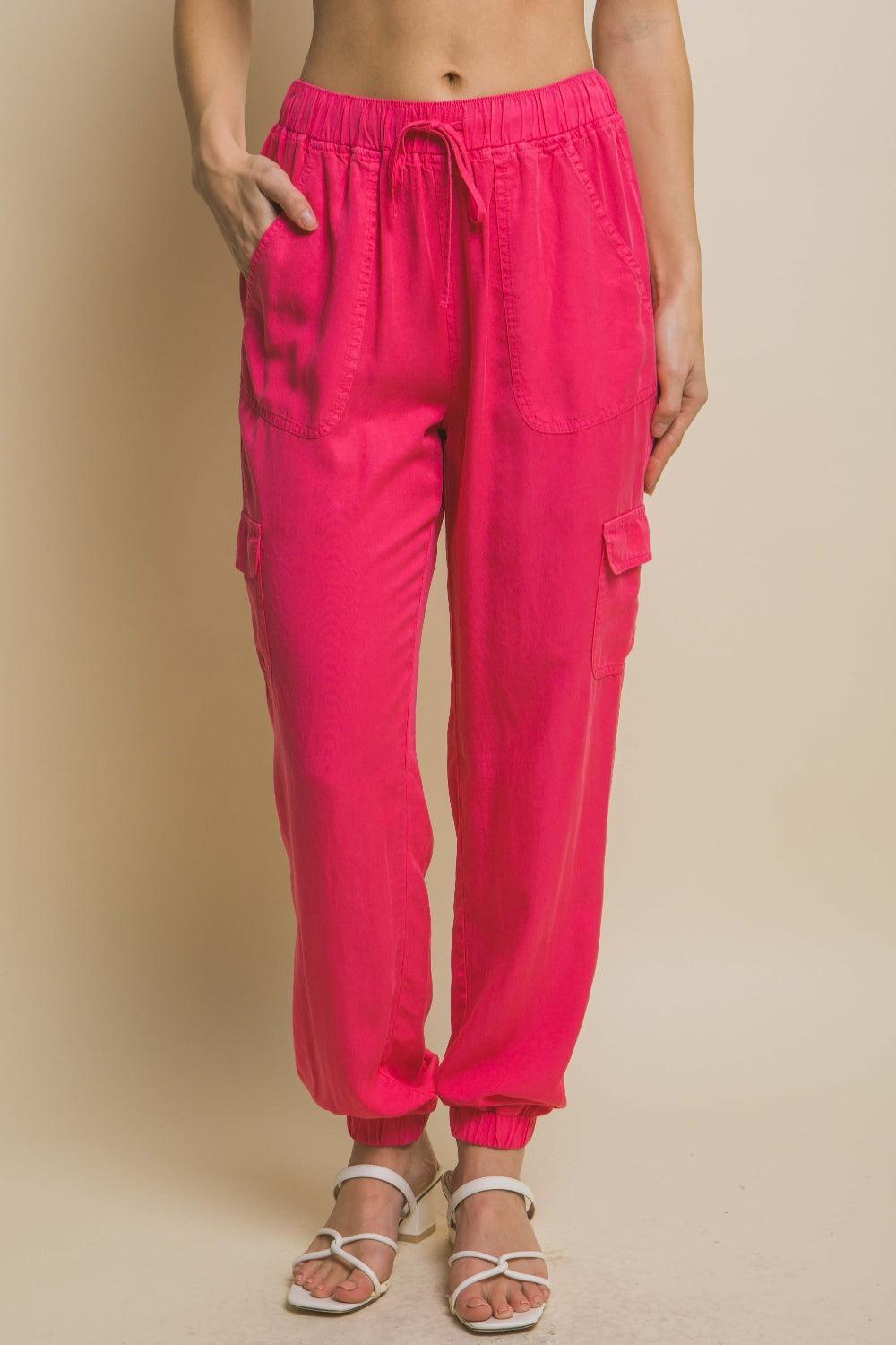 a woman wearing pink pants and sandals