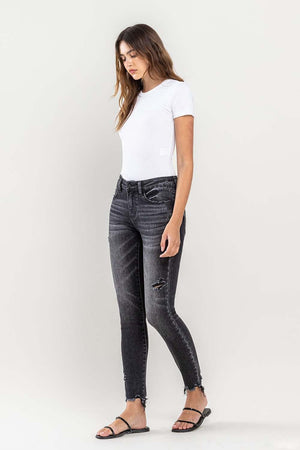 a woman in a white shirt and black jeans