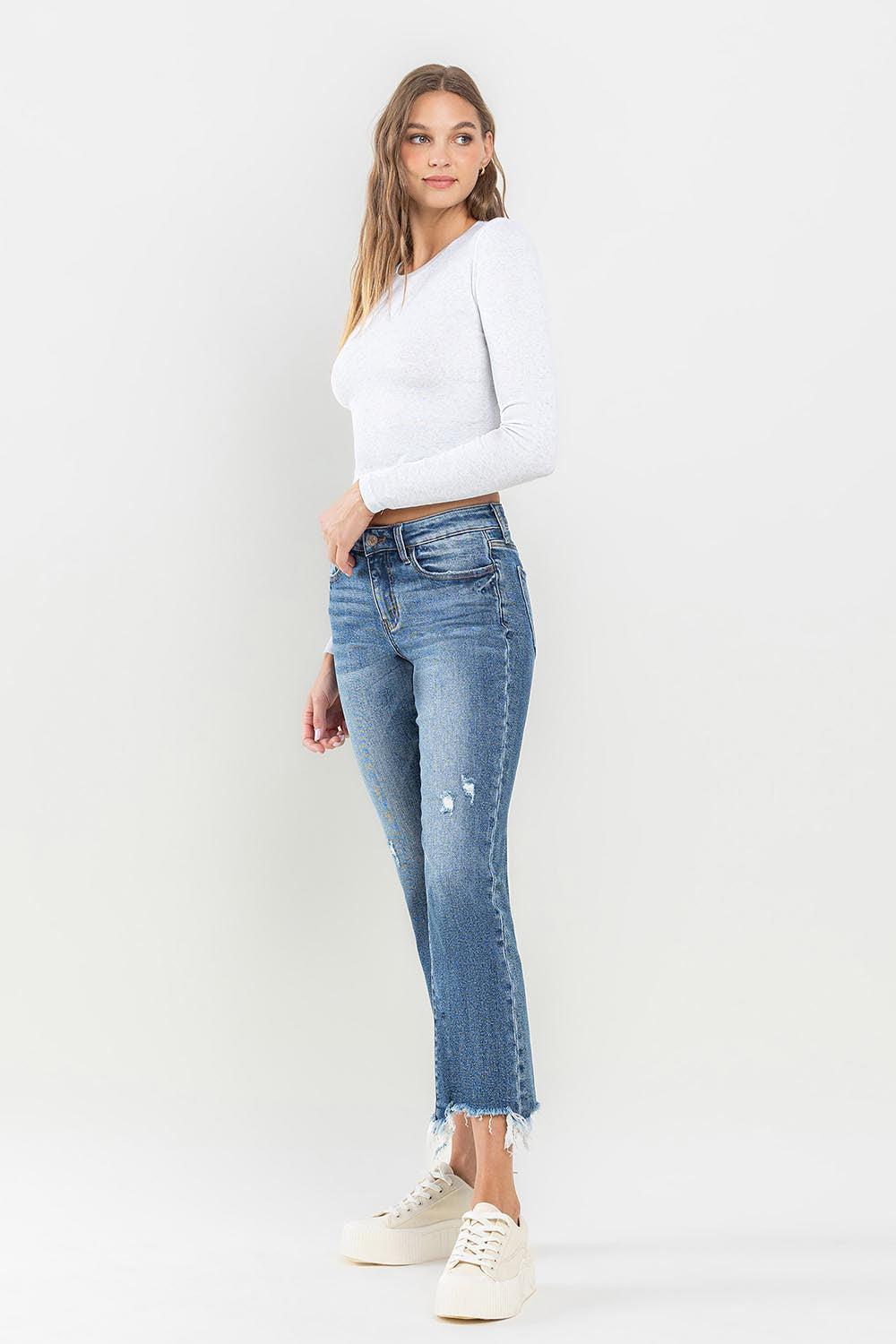 a woman wearing a white sweater and jeans