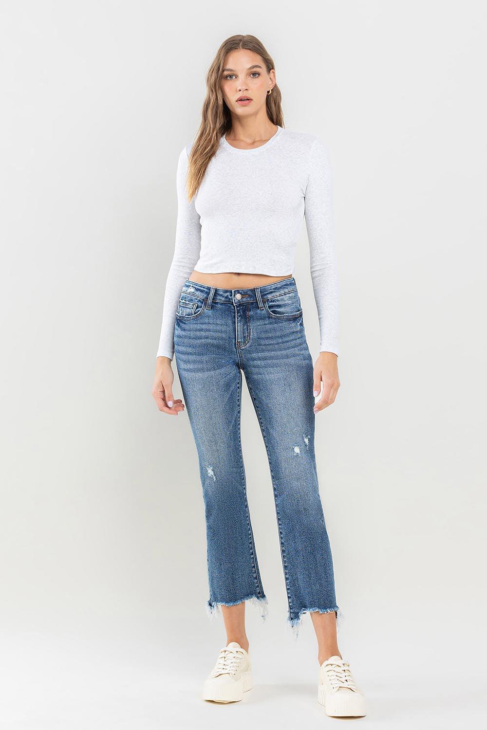 a woman in a white top and jeans