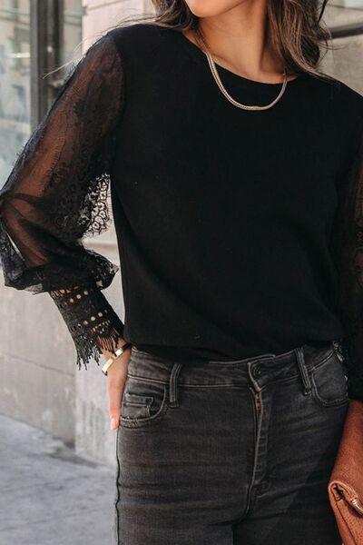 a woman wearing a black top and jeans