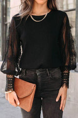 a woman in black shirt and jeans holding a brown purse