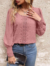 a woman wearing a pink blouse and jeans