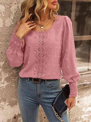 a woman wearing a pink blouse and jeans