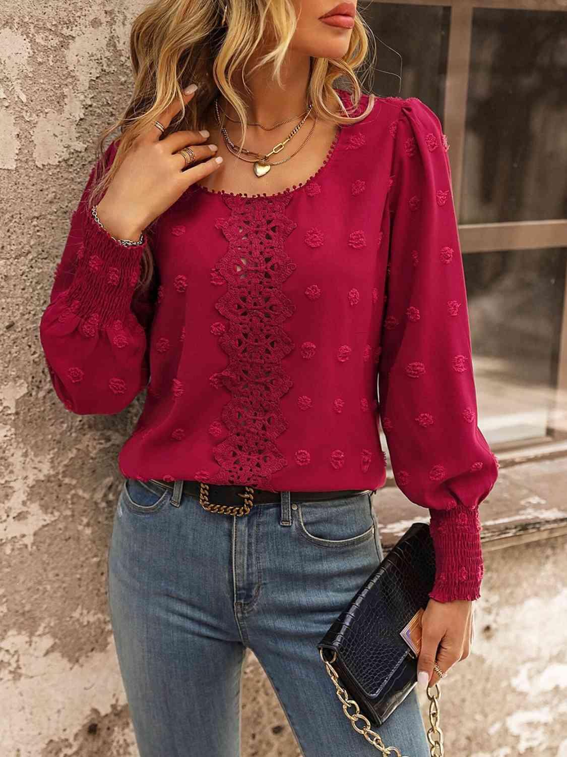 a woman wearing a red blouse and jeans