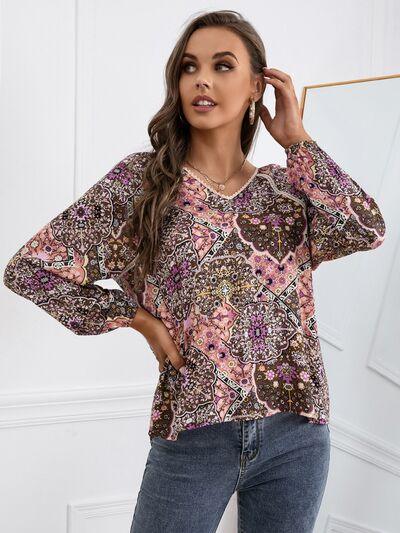 a woman wearing a top with a floral pattern