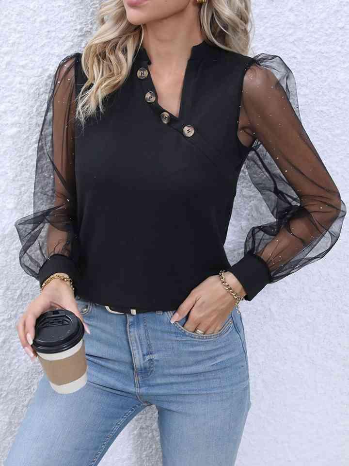 a woman wearing a black top and jeans